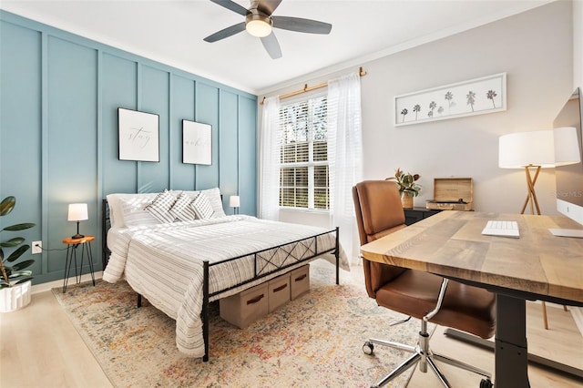 10412 White Lake Ct, Tampa, FL 33626 - bedroom with light wood-type flooring, an office area, crown molding, a ceiling fan, and a decorative wall