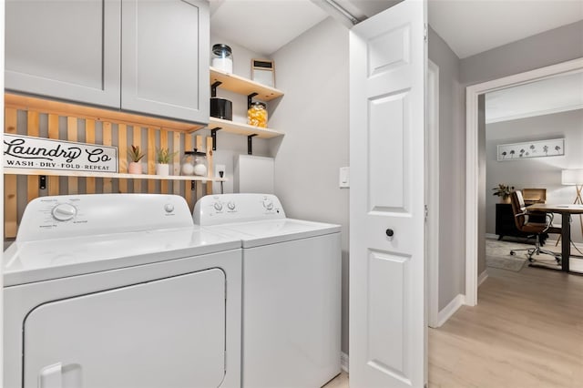 10412 White Lake Ct, Tampa, FL 33626 - laundry area with cabinet space, separate washer and dryer, light wood-type flooring, baseboards, and a desk