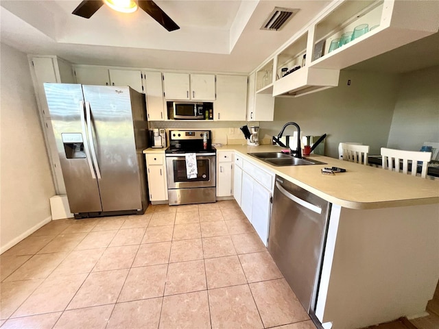 3725 Teeside Dr, New Port Richey, FL 34655 - kitchen with appliances with stainless steel finishes, a sink, a tray ceiling, light countertops, and ceiling fan