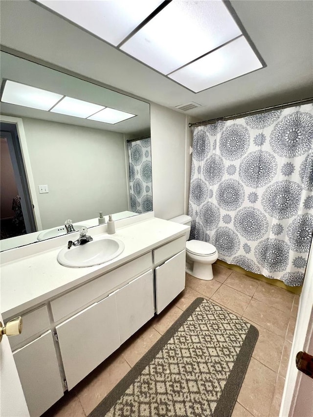3725 Teeside Dr, New Port Richey, FL 34655 - bathroom featuring vanity, toilet, tile patterned flooring, and a shower with curtain