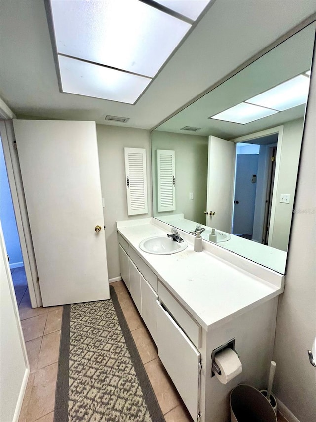 3725 Teeside Dr, New Port Richey, FL 34655 - bathroom with vanity, tile patterned flooring, and baseboards