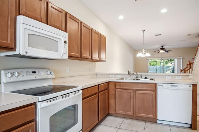 31215 Flannery Ct, Wesley Chapel, FL 33543 - kitchen featuring white appliances, a sink, a peninsula, brown cabinetry, and recessed lighting