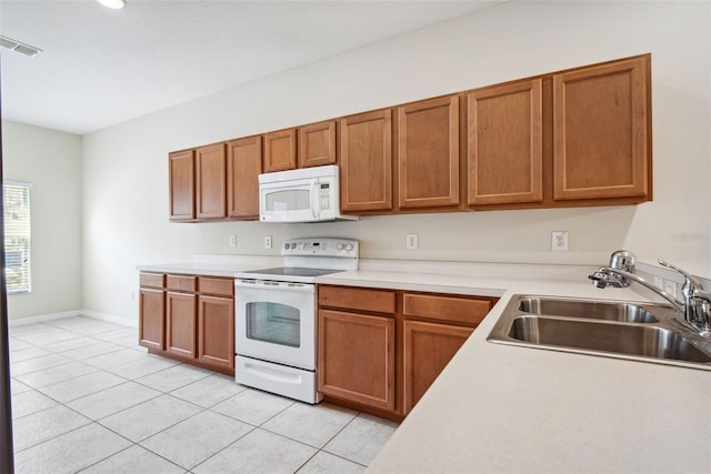 31215 Flannery Ct, Wesley Chapel, FL 33543 - kitchen featuring white appliances, a sink, light tile patterned flooring, light countertops, and brown cabinetry