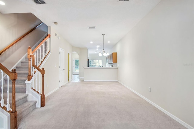 31215 Flannery Ct, Wesley Chapel, FL 33543 - unfurnished living room with a chandelier, baseboards, light carpet, recessed lighting, and stairs