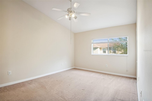 31215 Flannery Ct, Wesley Chapel, FL 33543 - spare room featuring light colored carpet, lofted ceiling, baseboards, and ceiling fan