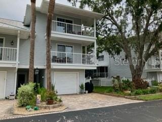 2015 Vista Del Sol Unit 108, Lutz, FL 33558 - view of front of home with driveway, a garage, and a balcony