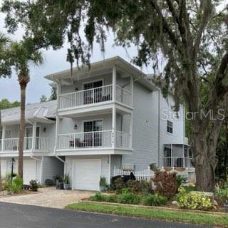2015 Vista Del Sol Unit 108, Lutz, FL 33558 - view of front of property featuring driveway and a garage