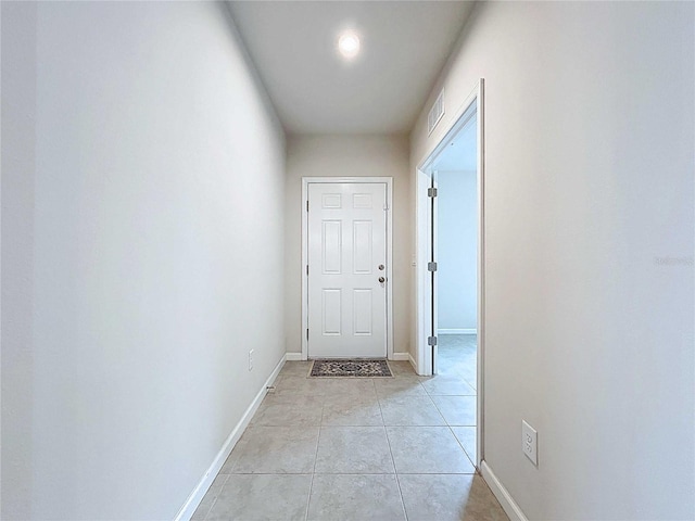 10347 Heron Hideaway Loop, Land O Lakes, FL 34638 - doorway featuring light tile patterned flooring and baseboards