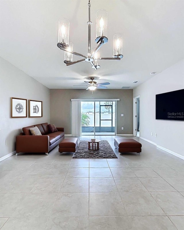 10347 Heron Hideaway Loop, Land O Lakes, FL 34638 - living area featuring a chandelier, ceiling fan, baseboards, and light tile patterned flooring