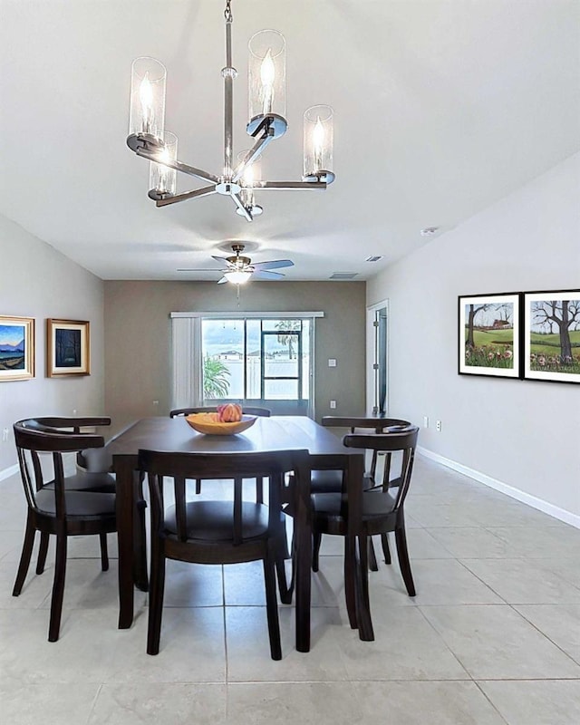 10347 Heron Hideaway Loop, Land O Lakes, FL 34638 - dining room with a chandelier, ceiling fan, lofted ceiling, baseboards, and light tile patterned floors
