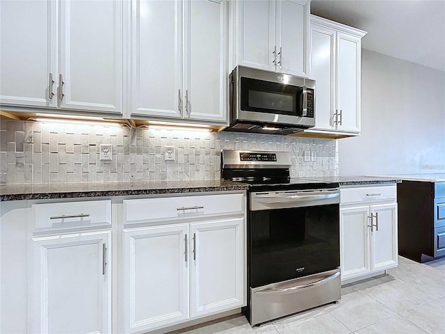 10347 Heron Hideaway Loop, Land O Lakes, FL 34638 - kitchen with stainless steel appliances, dark stone counters, tasteful backsplash, and white cabinets