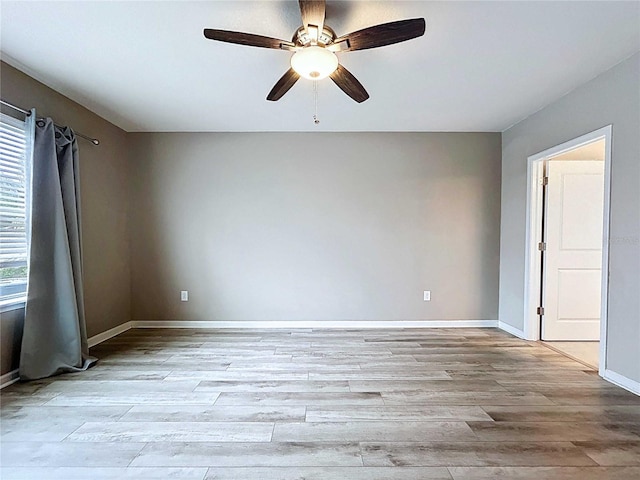 10347 Heron Hideaway Loop, Land O Lakes, FL 34638 - empty room with light wood-style floors, ceiling fan, and baseboards