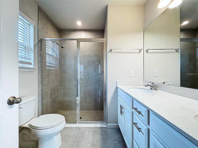 10347 Heron Hideaway Loop, Land O Lakes, FL 34638 - full bathroom with toilet, double vanity, tile patterned flooring, and a stall shower