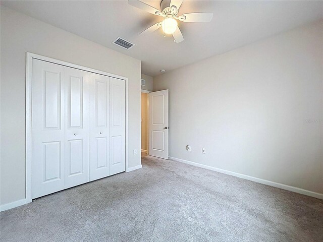 10347 Heron Hideaway Loop, Land O Lakes, FL 34638 - unfurnished bedroom featuring carpet floors, baseboards, a closet, and a ceiling fan