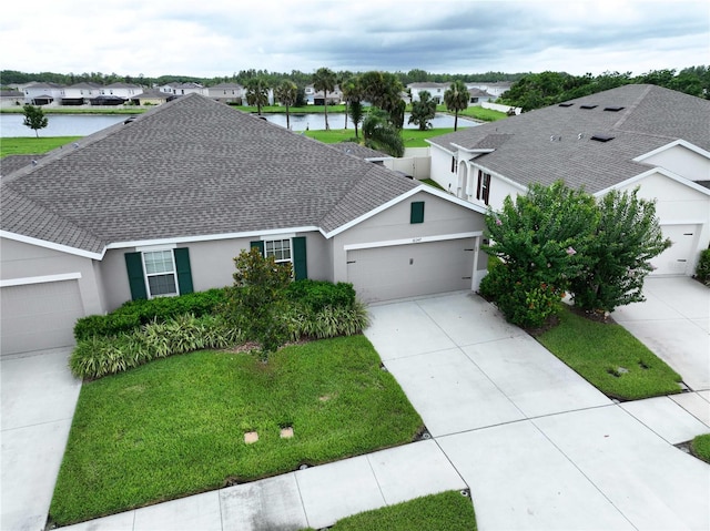 10347 Heron Hideaway Loop, Land O Lakes, FL 34638 - single story home featuring a shingled roof, a garage, driveway, stucco siding, and a front lawn