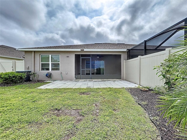 10347 Heron Hideaway Loop, Land O Lakes, FL 34638 - rear view of property with stucco siding, a patio area, and central air condition unit