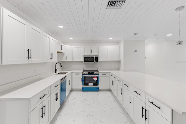 3552 Middletown St, Port Charlotte, FL 33952 - kitchen with appliances with stainless steel finishes, a sink, a peninsula, light marble finish floors, and recessed lighting