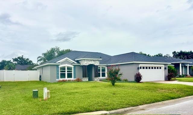 7144 Remington Oaks Loop, Lakeland, FL 33810 - single story home featuring driveway, a garage, and stucco siding