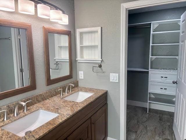 7144 Remington Oaks Loop, Lakeland, FL 33810 - full bathroom featuring double vanity and baseboards
