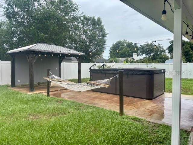 7144 Remington Oaks Loop, Lakeland, FL 33810 - view of yard with a hot tub, a gazebo, and a patio area