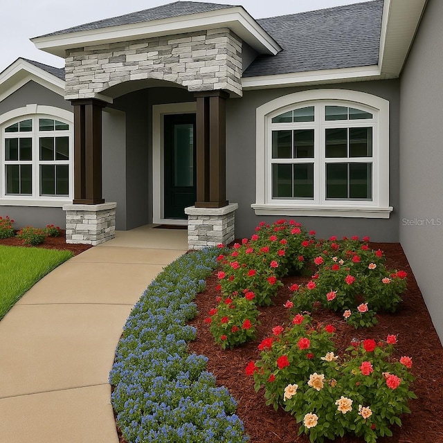 7144 Remington Oaks Loop, Lakeland, FL 33810 - view of exterior entry with stone siding and stucco siding