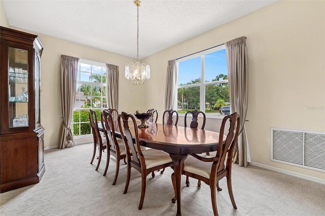 18219 Bittern Ave, Lutz, FL 33558 - dining space featuring light carpet, a chandelier, healthy amount of natural light, and a textured ceiling