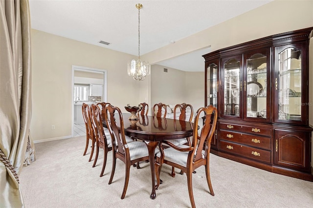 18219 Bittern Ave, Lutz, FL 33558 - dining room with a chandelier and light colored carpet