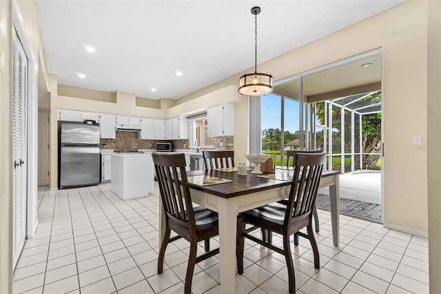 18219 Bittern Ave, Lutz, FL 33558 - dining area with light tile patterned floors and recessed lighting