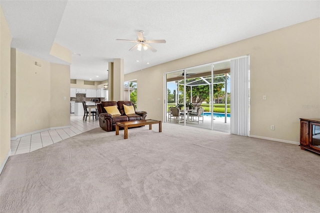 18219 Bittern Ave, Lutz, FL 33558 - living room featuring ceiling fan, a sunroom, carpet, and tile patterned floors
