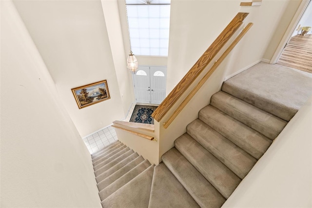 18219 Bittern Ave, Lutz, FL 33558 - stairway with a towering ceiling, plenty of natural light, carpet, and tile patterned flooring