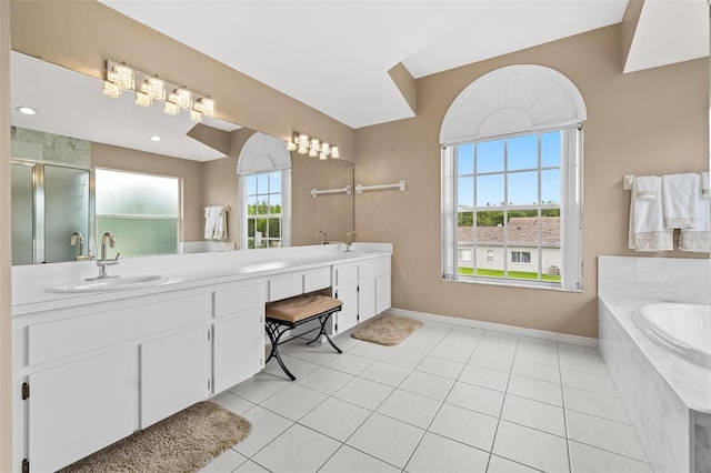 18219 Bittern Ave, Lutz, FL 33558 - bathroom with double vanity, a garden tub, a stall shower, and tile patterned floors