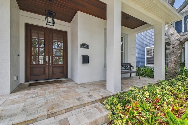 2522 W Watrous Ave, Tampa, FL 33629 - doorway to property featuring french doors, a porch, and stucco siding
