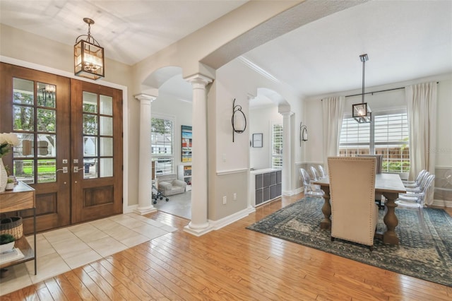 2522 W Watrous Ave, Tampa, FL 33629 - foyer entrance with decorative columns, arched walkways, hardwood / wood-style floors, french doors, and a chandelier