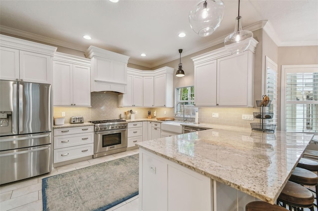 2522 W Watrous Ave, Tampa, FL 33629 - kitchen featuring appliances with stainless steel finishes, a sink, a peninsula, custom exhaust hood, and light stone counters
