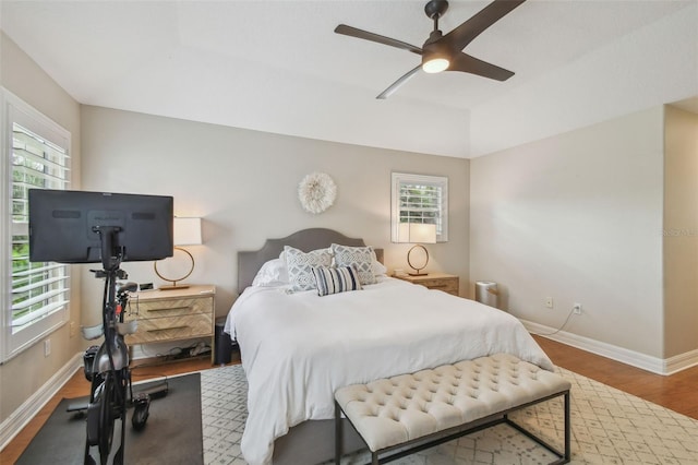 2522 W Watrous Ave, Tampa, FL 33629 - bedroom featuring multiple windows, baseboards, wood finished floors, and a ceiling fan