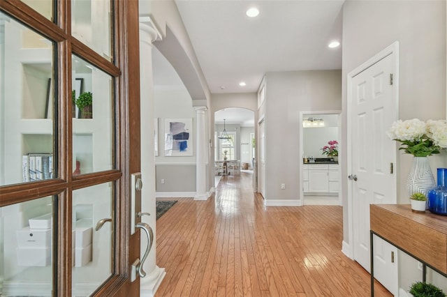 2522 W Watrous Ave, Tampa, FL 33629 - hall featuring arched walkways, light wood finished floors, baseboards, recessed lighting, and ornate columns
