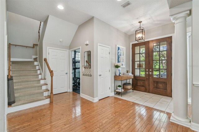 2522 W Watrous Ave, Tampa, FL 33629 - foyer entrance with baseboards, light wood-type flooring, stairway, ornate columns, and french doors