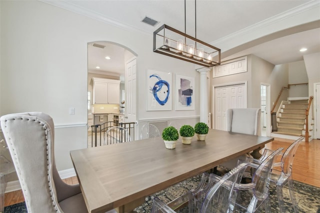 2522 W Watrous Ave, Tampa, FL 33629 - dining area with ornamental molding, arched walkways, wood finished floors, stairway, and recessed lighting