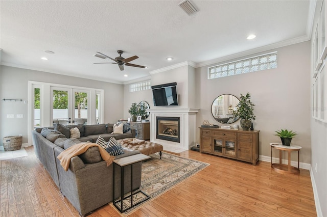 2522 W Watrous Ave, Tampa, FL 33629 - living room with ceiling fan, recessed lighting, light wood-type flooring, crown molding, and baseboards