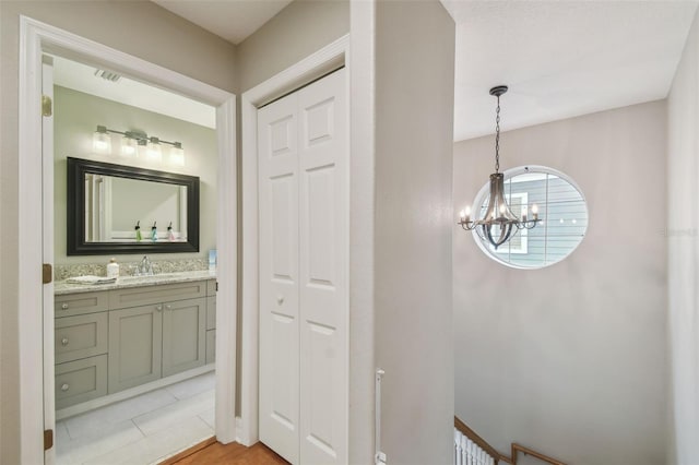 2522 W Watrous Ave, Tampa, FL 33629 - bathroom with a chandelier, vanity, tile patterned flooring, and a closet