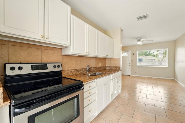 6941 58th Way N, Pinellas Park, FL 33781 - kitchen with electric range, a sink, backsplash, stone counters, and white cabinets