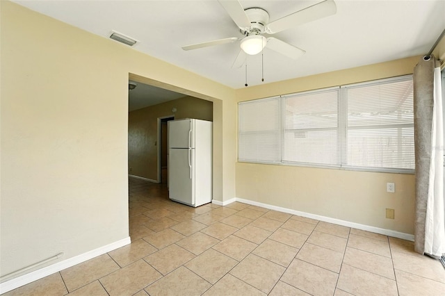 6941 58th Way N, Pinellas Park, FL 33781 - empty room featuring a ceiling fan, light tile patterned flooring, and baseboards
