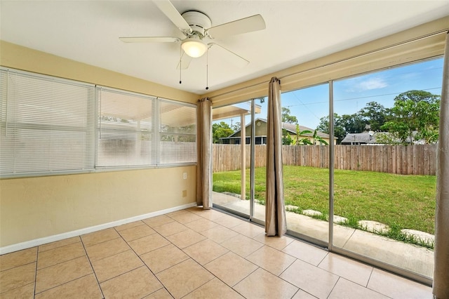 6941 58th Way N, Pinellas Park, FL 33781 - unfurnished sunroom featuring tile patterned flooring, a ceiling fan, and baseboards