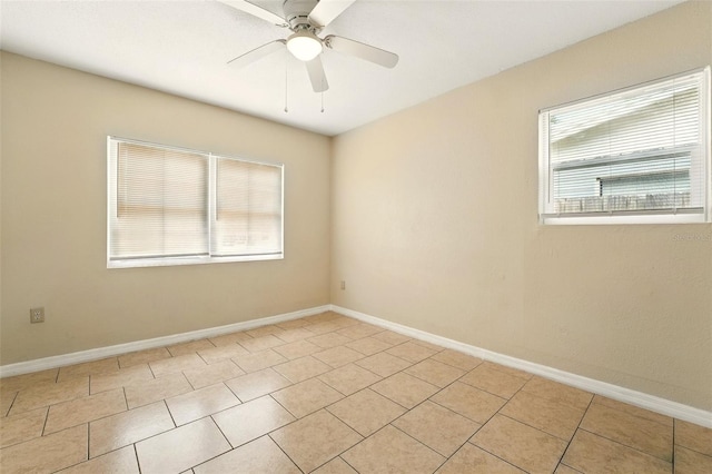 6941 58th Way N, Pinellas Park, FL 33781 - spare room featuring plenty of natural light, a ceiling fan, light tile patterned floors, and baseboards