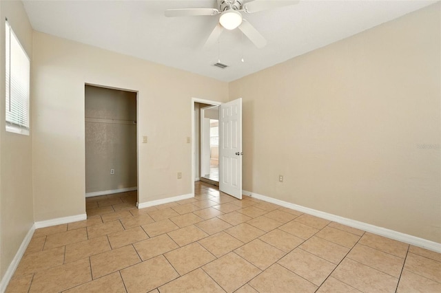 6941 58th Way N, Pinellas Park, FL 33781 - unfurnished bedroom featuring light tile patterned flooring, a closet, ceiling fan, and baseboards