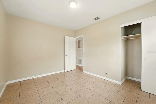 6941 58th Way N, Pinellas Park, FL 33781 - unfurnished bedroom featuring light tile patterned flooring, a closet, and baseboards