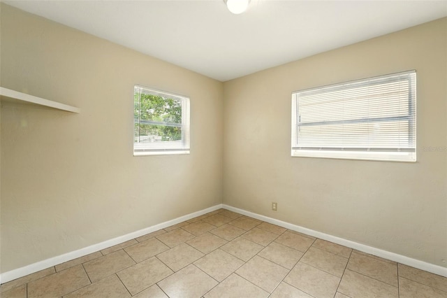 6941 58th Way N, Pinellas Park, FL 33781 - empty room featuring baseboards and light tile patterned floors