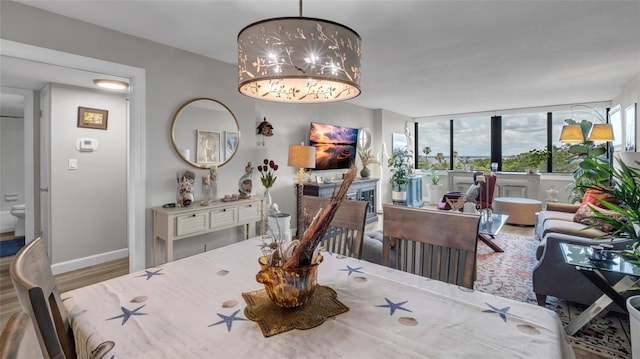 2616 Cove Cay Dr Unit 505, Clearwater, FL 33760 - dining room with wood finished floors and a fireplace