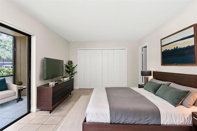 11805 Raintree Lake Ln Unit A, Tampa, FL 33617 - bedroom featuring light tile patterned floors, a closet, and baseboards
