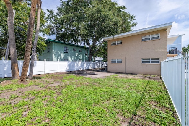 1799 Russell St S, Saint Petersburg, FL 33712 - rear view of property with a fenced backyard, stucco siding, and a patio